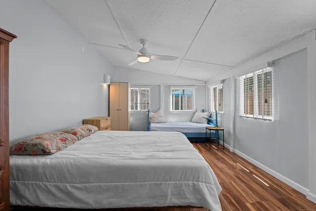 a bedroom with a large bed and a window