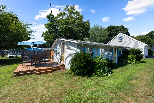 a view of a house with backyard sitting area and garden