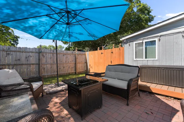 a view of backyard with tub and trees in the background