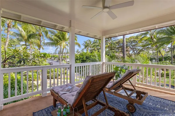 a view of a porch with furniture and wooden floor