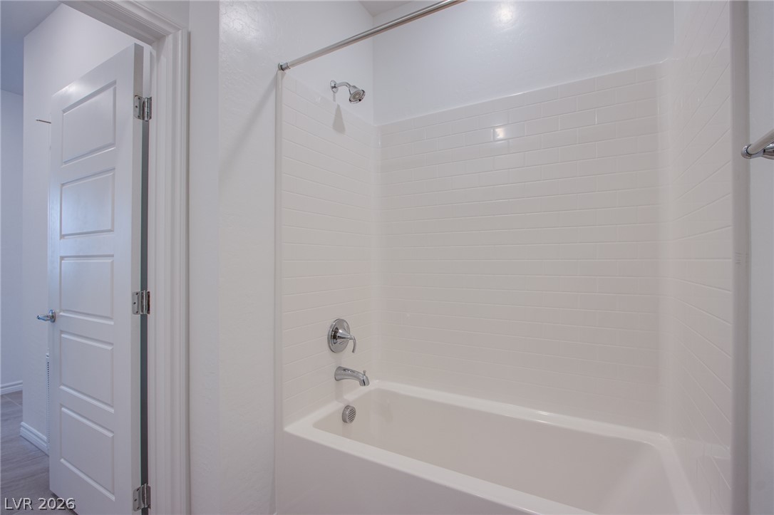 2555 Hampton Road, Unit 11201 Henderson, NV 89052 - Photo 16 of 24 Clean subway tile lines the shower and tub enclosure in this fresh bathroom.
