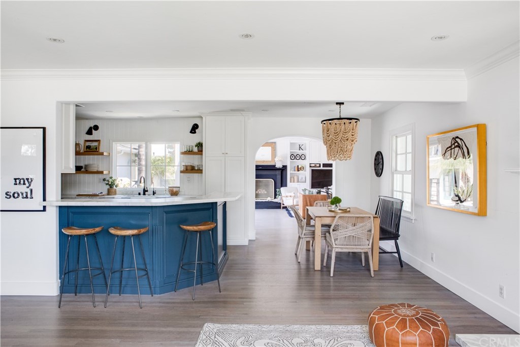 a dining room with furniture and wooden floor