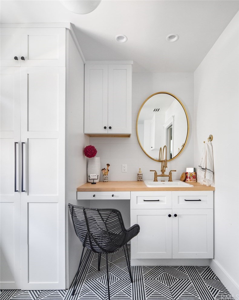 418 Broadway Costa Mesa, CA 92627 - Photo 11 of 27 a room with a sink a vanity and a mirror