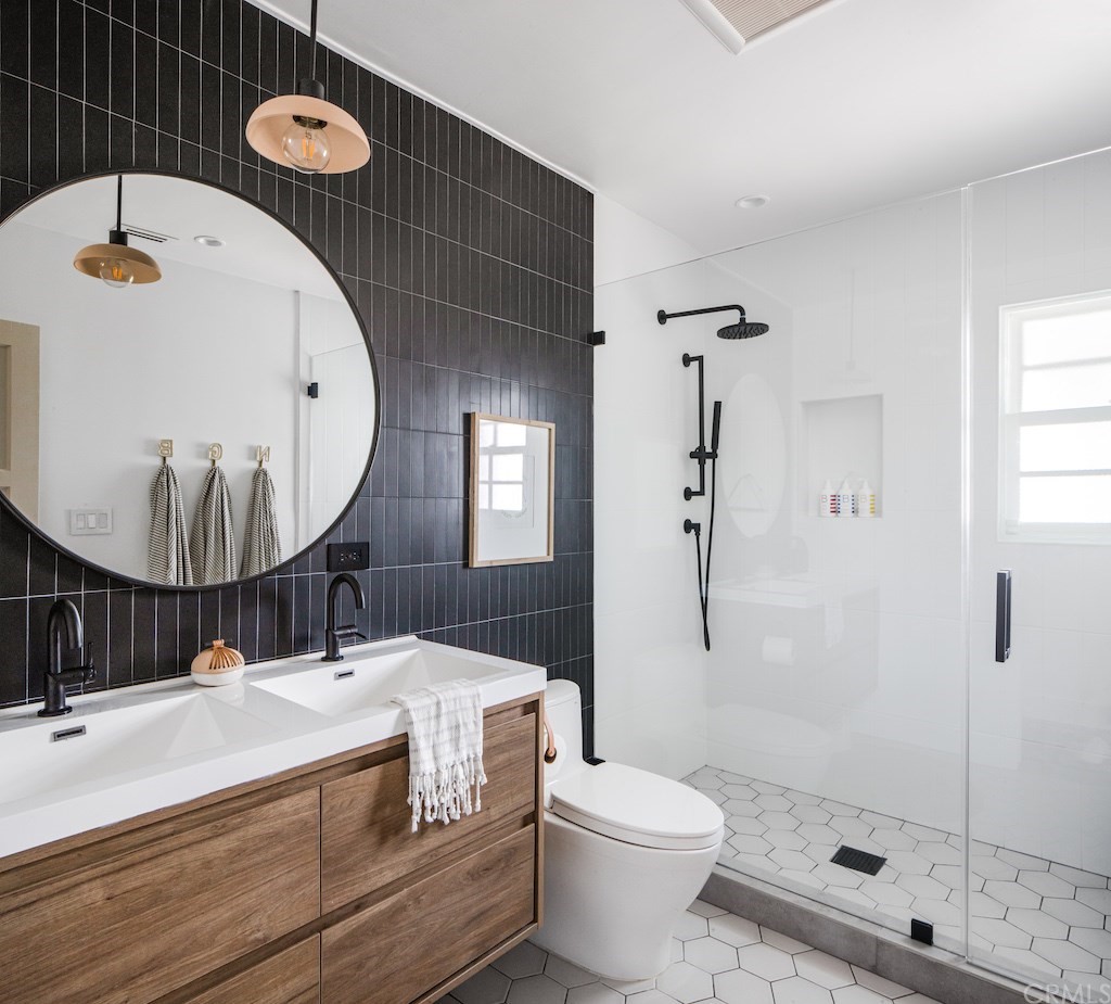 418 Broadway Costa Mesa, CA 92627 - Photo 17 of 27 a bathroom with a sink mirror vanity and toilet