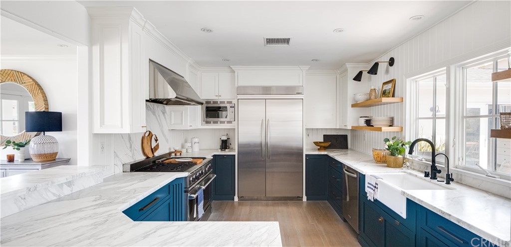 418 Broadway Costa Mesa, CA 92627 - Photo 5 of 27 a kitchen with stainless steel appliances granite countertop a sink stove and refrigerator