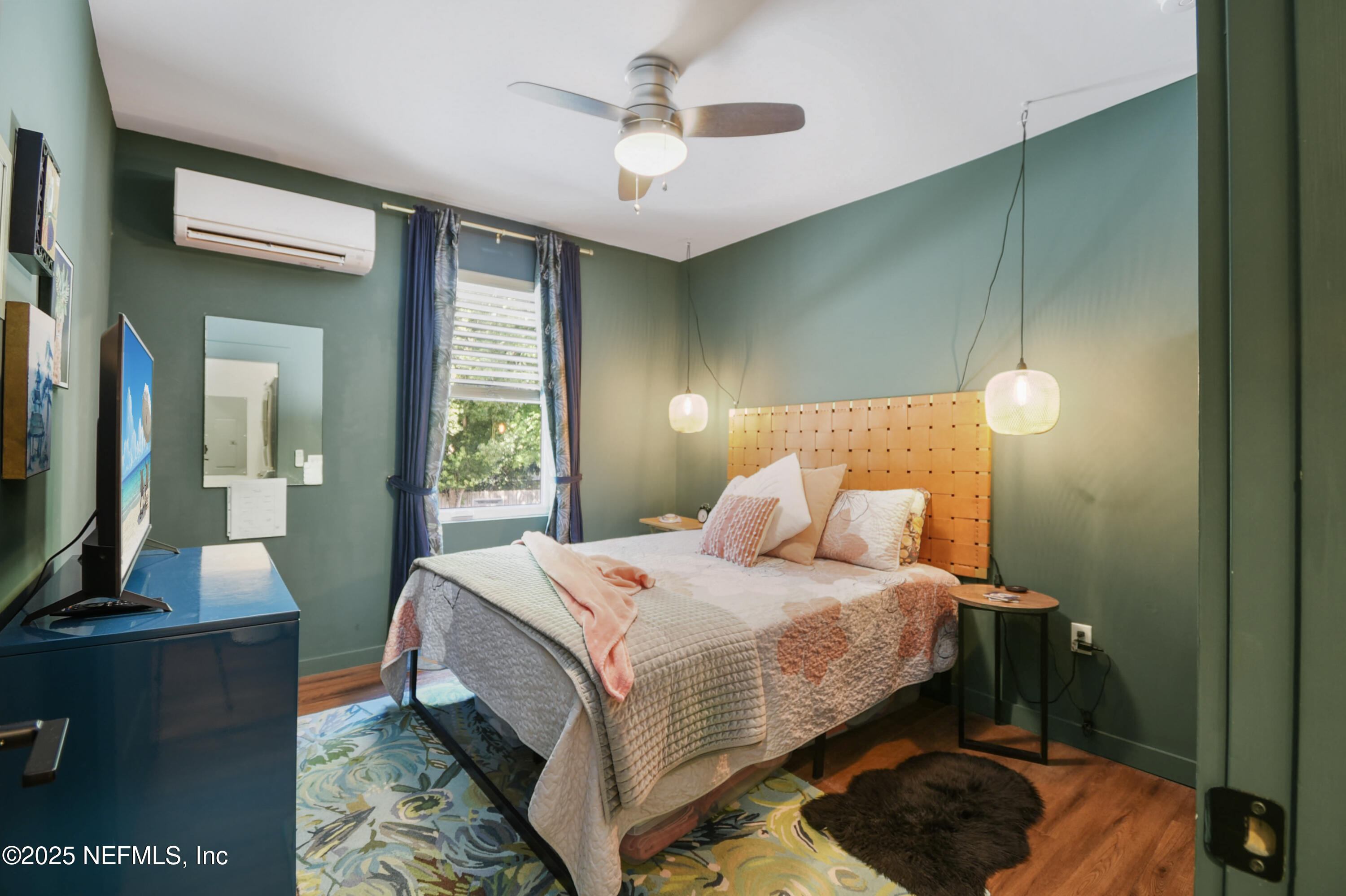 55 South Dixie Highway St. Augustine, FL 32084 - Photo 14 of 41 a bedroom with a bed and a chandelier