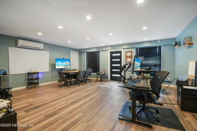 a backyard of a house with large trees and a wooden fence