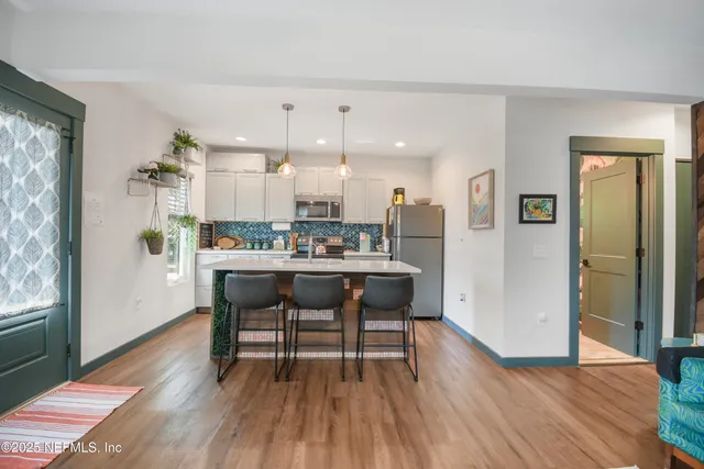 a bedroom with a bed and painting on the wall