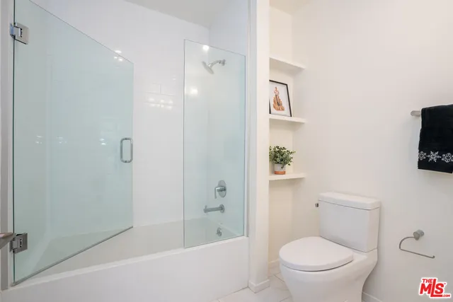 a bathroom with a toilet a sink and bathtub