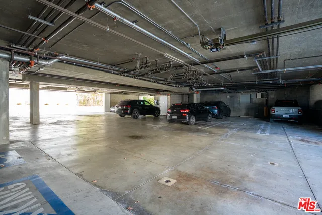 a view of parking garage with cars