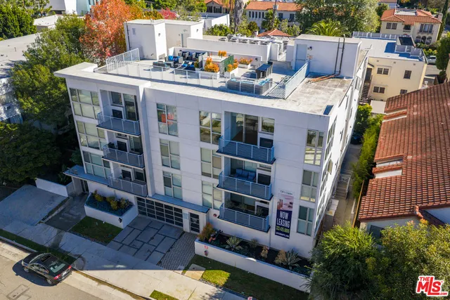 a view of roof deck with barbeque grill and outdoor seating