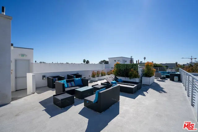 a view of roof deck with furniture