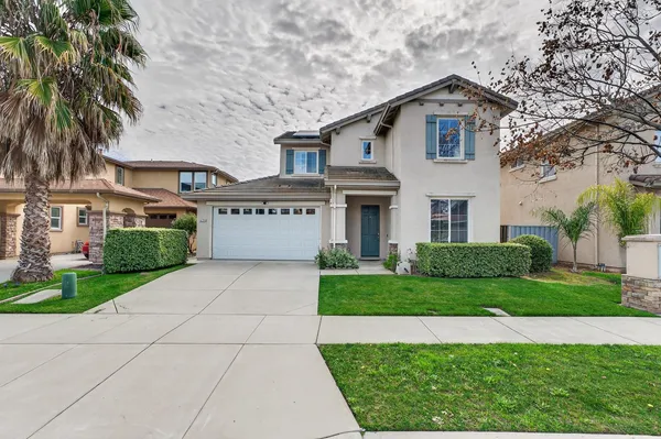 a view of house with yard and green space