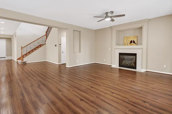 wooden floor in an empty room with a fireplace