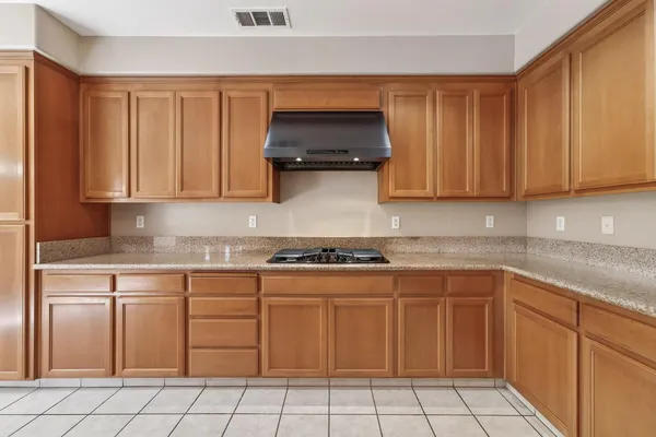 a kitchen with cabinets and appliances