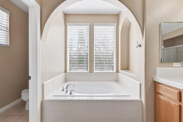 a bathroom with bathtub and window