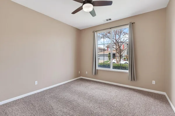 an empty room with windows and city view