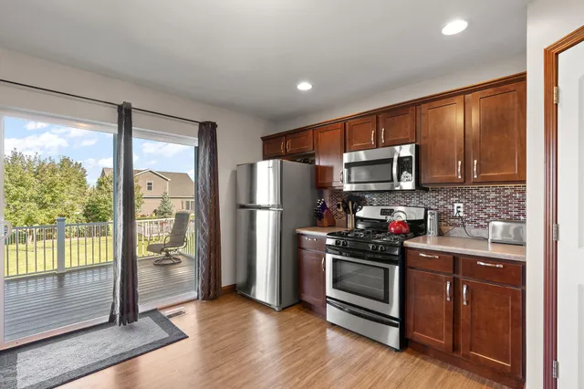 a kitchen with stainless steel appliances a refrigerator sink and microwave