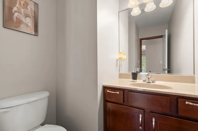 a bathroom with a toilet sink and mirror