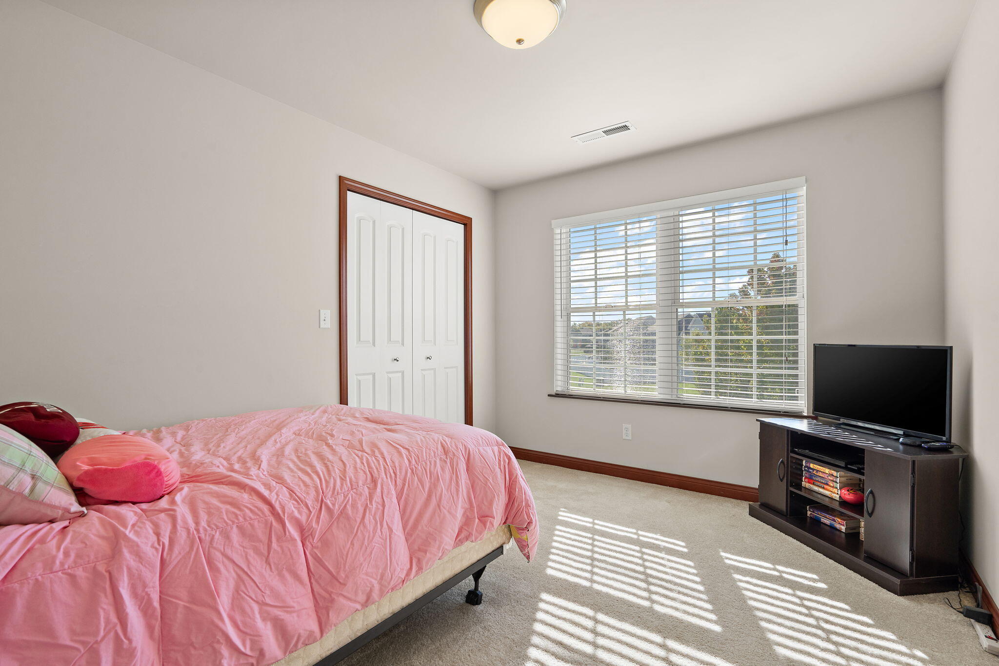 1156 Donegal Lane Crown Point, IN 46307 - Photo 18 of 25 a bedroom with a bed and a flat tv screen on a dresser