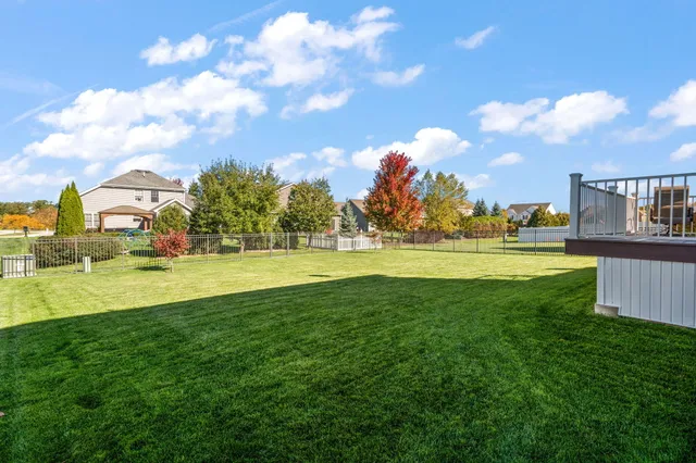 a view of a swimming pool and a yard
