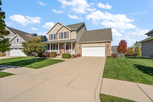 a view of house with a yard and potted plants