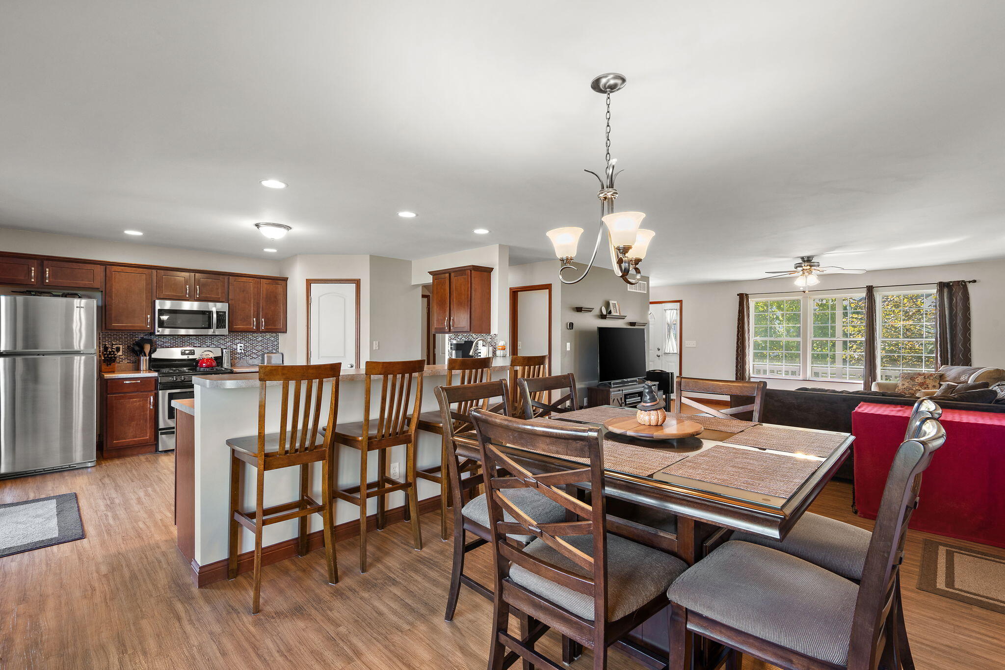 1156 Donegal Lane Crown Point, IN 46307 - Photo 9 of 25 a view of a dining room and livingroom with furniture wooden floor a chandelier