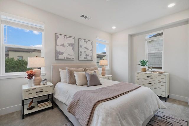 a bedroom with a bed and a night stand