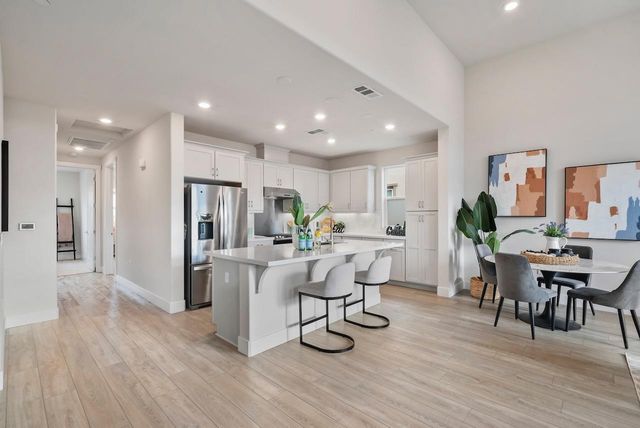 a view of kitchen with refrigerator and wooden floor