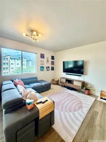 a bedroom with two beds and a flat screen tv