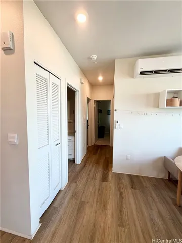 a view of a hallway with wooden floor