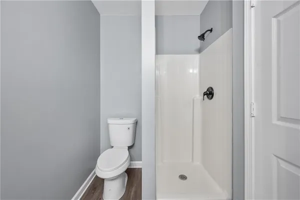a bathroom with a toilet and a shower