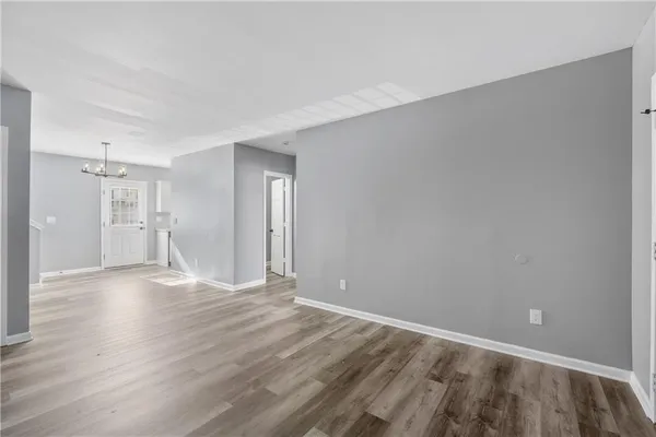 a view of an empty room and wooden floor
