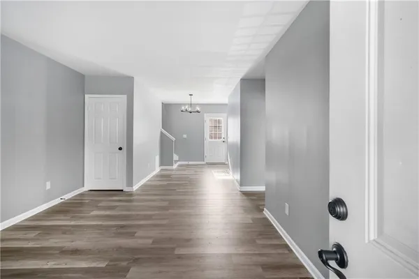 a view of a hallway with wooden floor