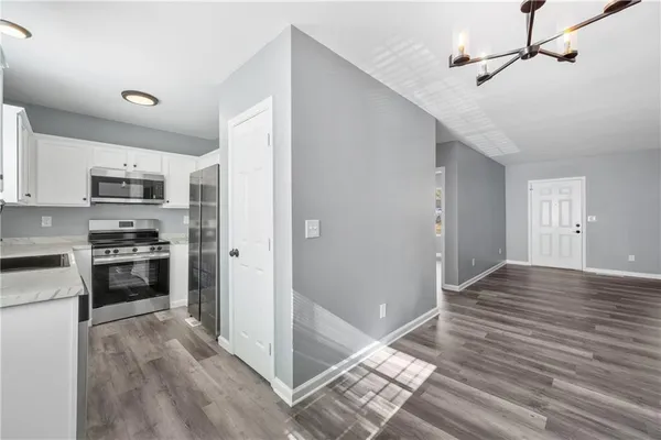 a view of kitchen with sink microwave and refrigerator