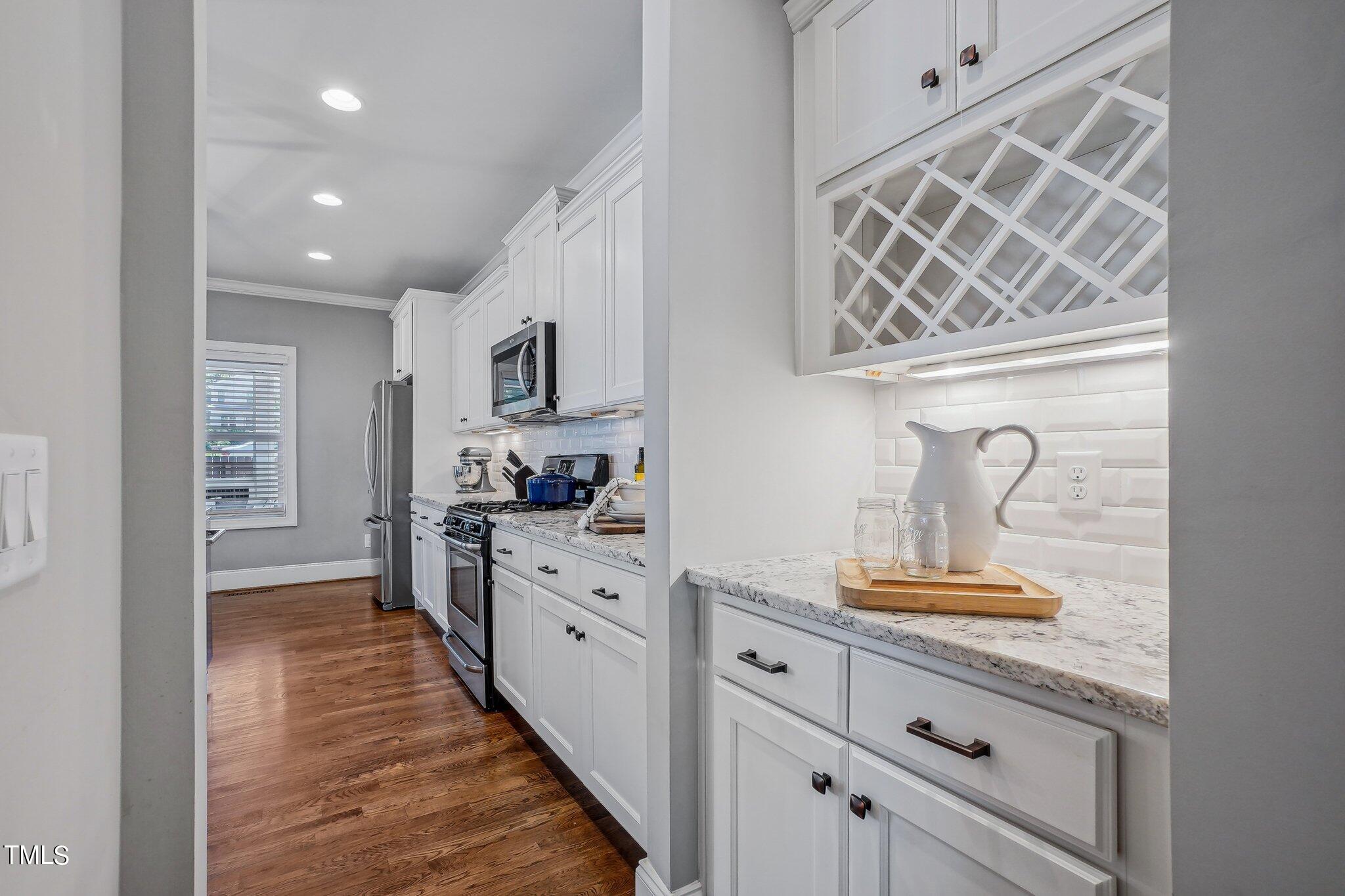103 Pineland Circle Raleigh, NC 27606 - Photo 14 of 62 a kitchen with cabinets and window