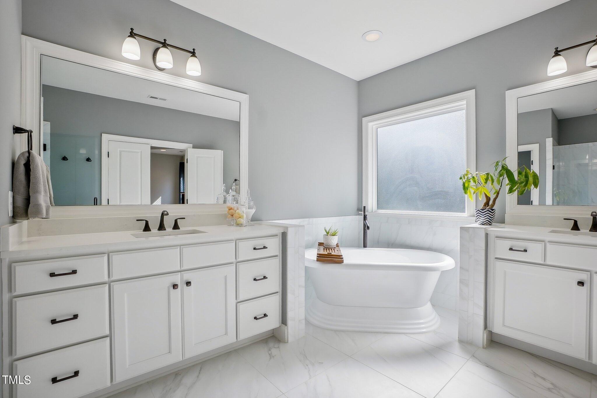 103 Pineland Circle Raleigh, NC 27606 - Photo 21 of 62 a bathroom with a toilet a sink a tub and mirror