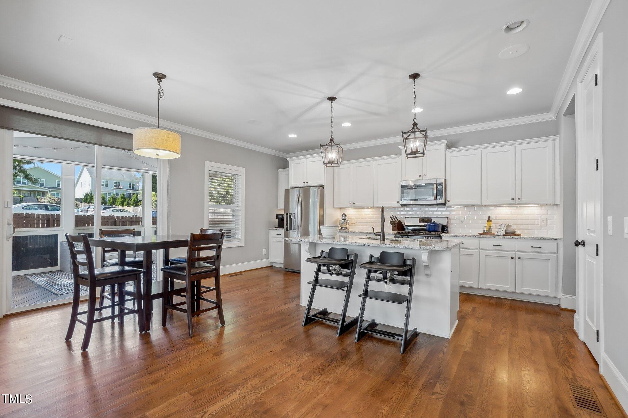 103 Pineland Circle Raleigh, NC 27606 - Photo 10 of 62 a view of a dining room with furniture window and wooden floor
