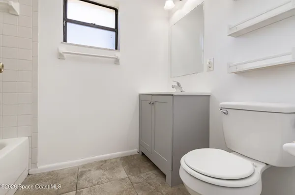 a white toilet sitting next to a bathroom sink