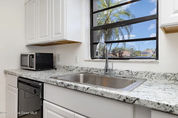 a close view of sink and cabinets