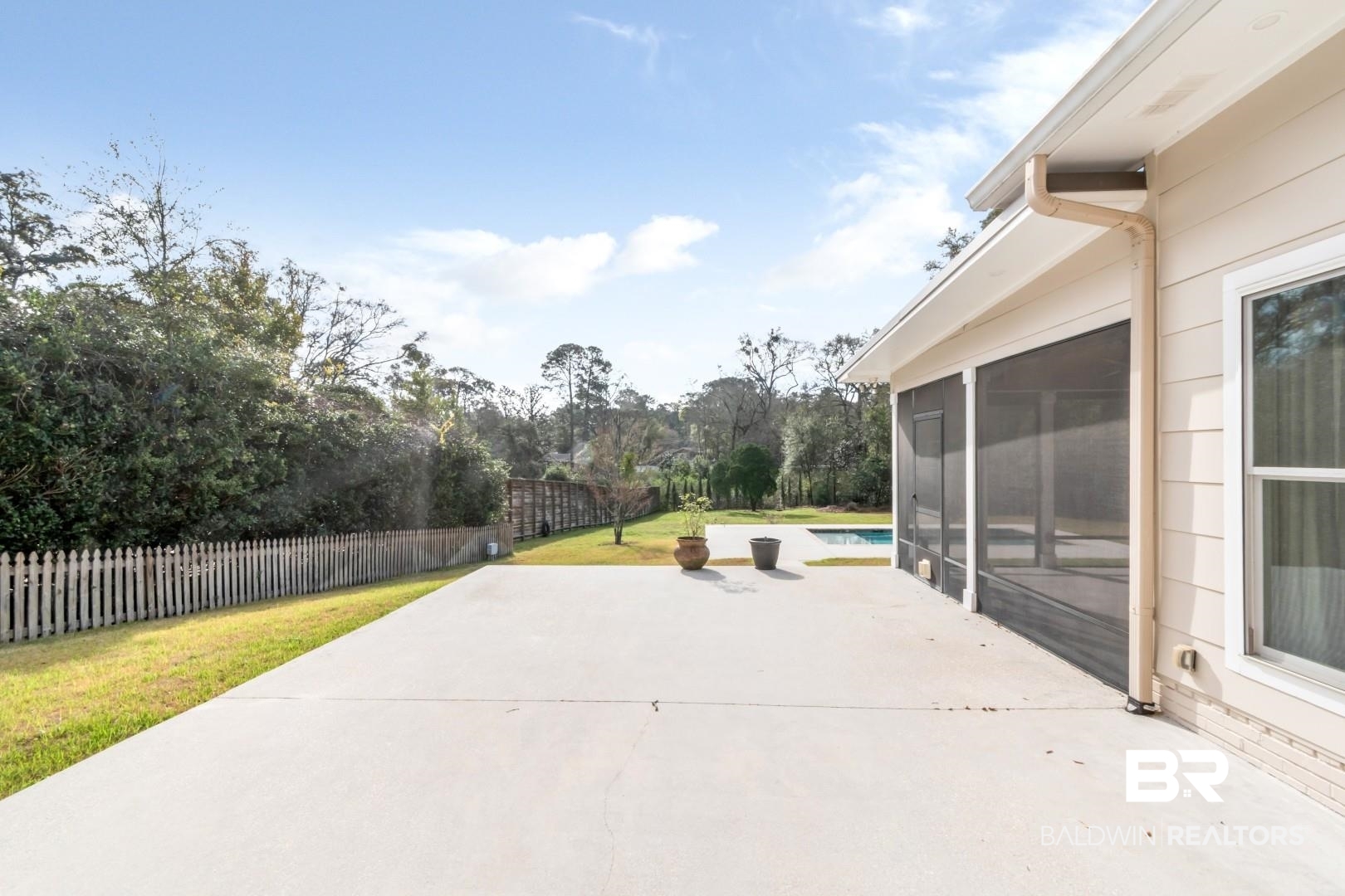 231 Rochester Road Mobile, AL 36608 - Photo 40 of 51 Fenced backyard featuring a patio, a sunroom, and view of scattered trees