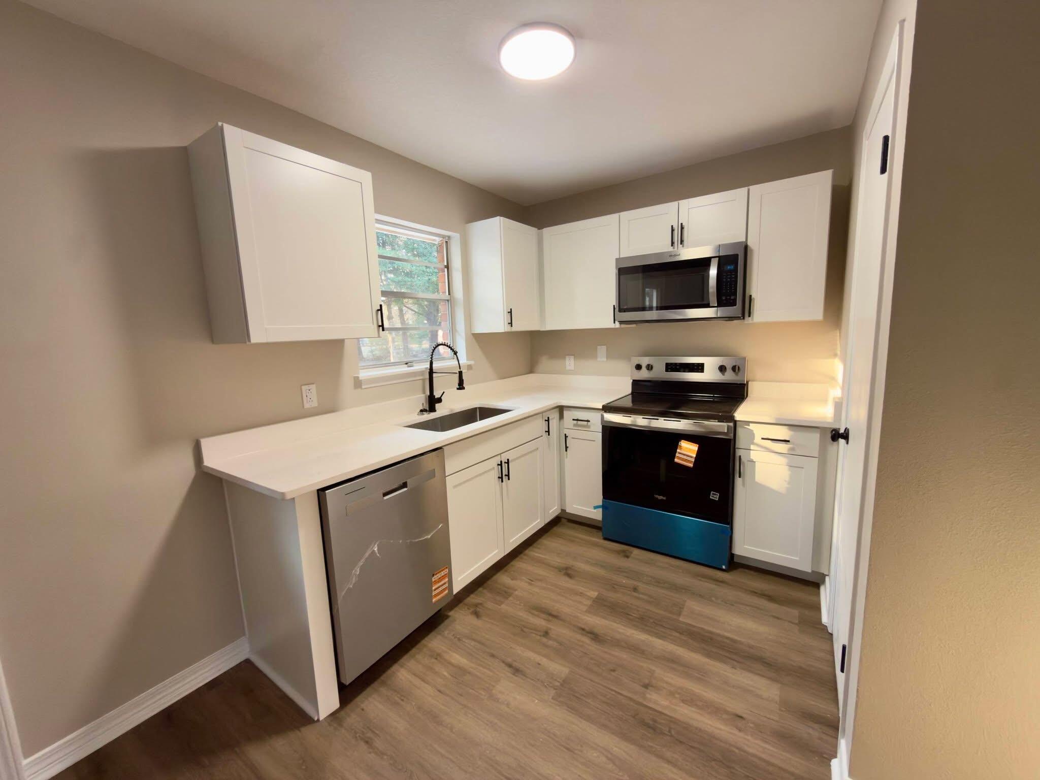 215 Jones Road Crestview, FL 32536 - Photo 3 of 9 a kitchen with a sink cabinets and a window