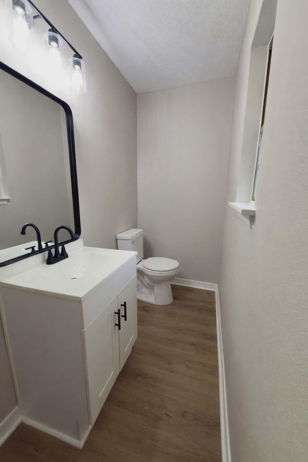 215 Jones Road Crestview, FL 32536 - Photo 7 of 9 a bathroom with a sink a toilet and mirror