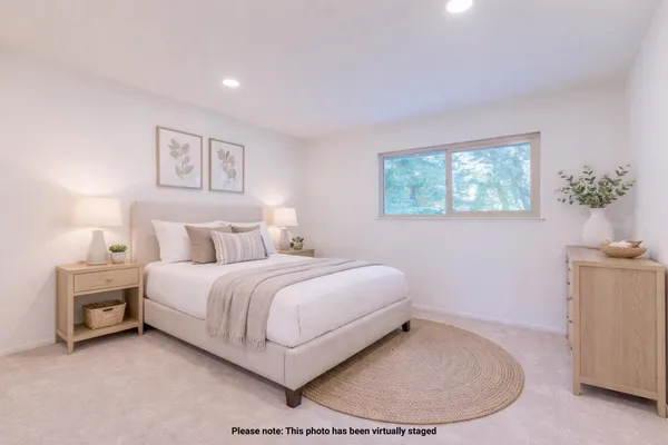 a bedroom with a bed and a potted plant