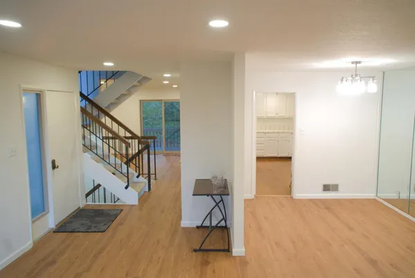 a view of entryway and hall with wooden floor