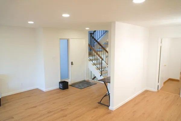 a bedroom with a bed and a potted plant