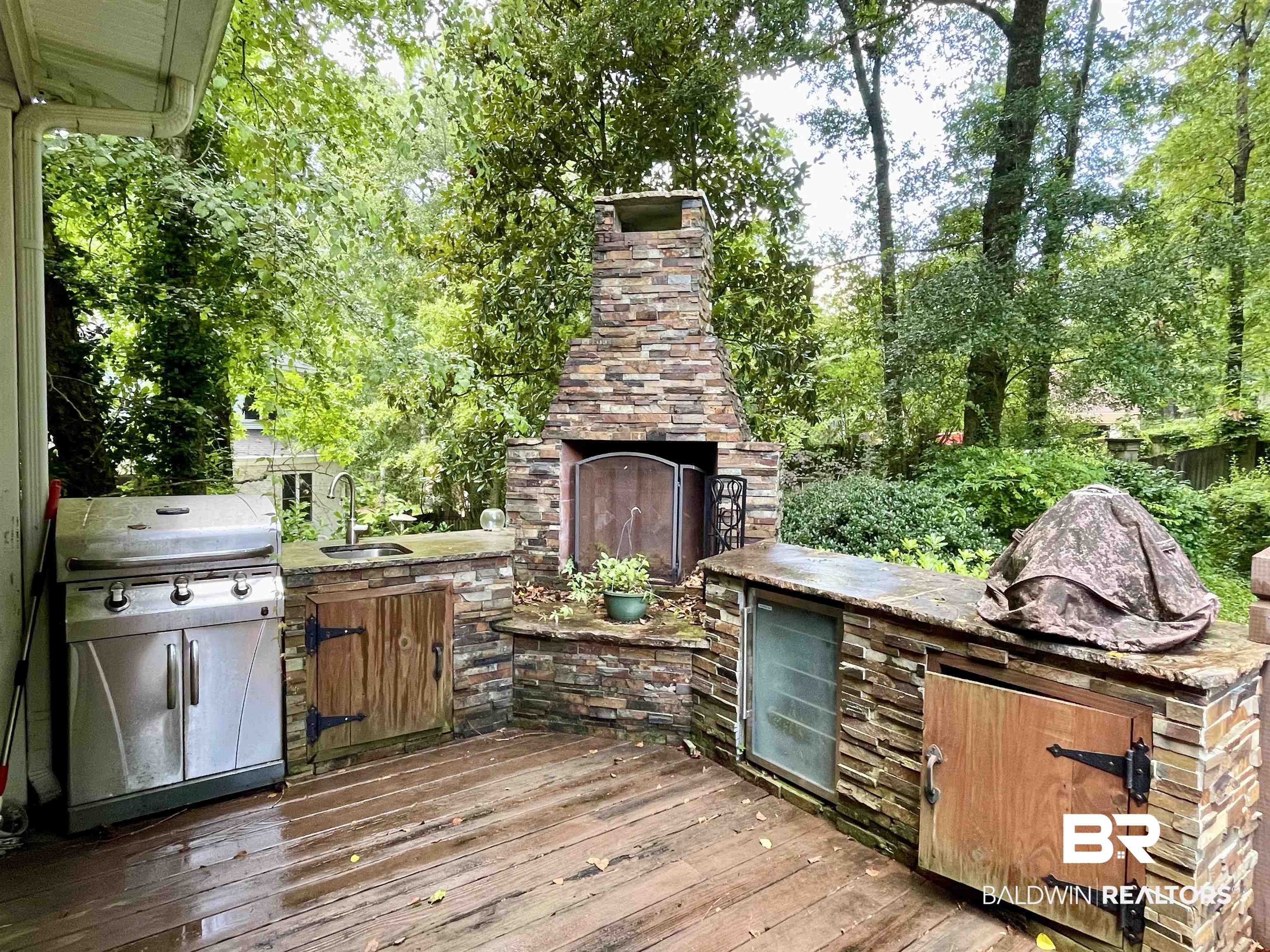 202 Potters Mills Road Daphne, AL 36526 - Photo 25 of 29 Wooden deck with area for grilling, an outdoor stone fireplace, and sink