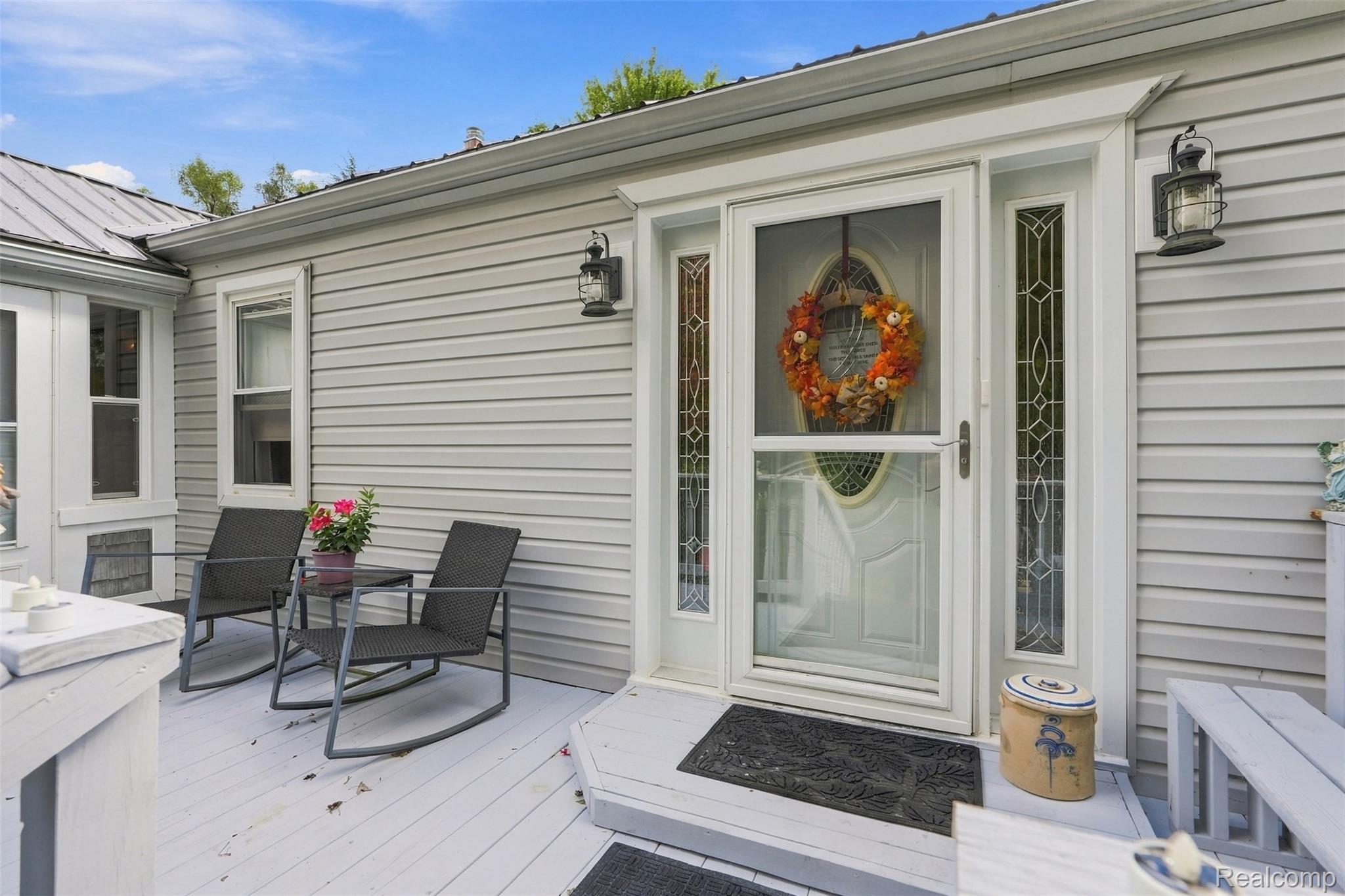 36739 Wick Road Romulus, MI 48174 - Photo 3 of 56 Light gray siding exterior with a metal roof