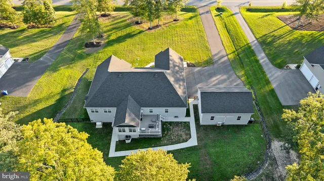a bathroom with a granite countertop toilet sink and mirror