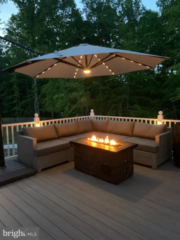 a bathroom with a granite countertop bathtub shower sink vanity and toilet